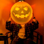 A jack-o-lantern face glows at the Exploratorium Creepatorium Halloween science party