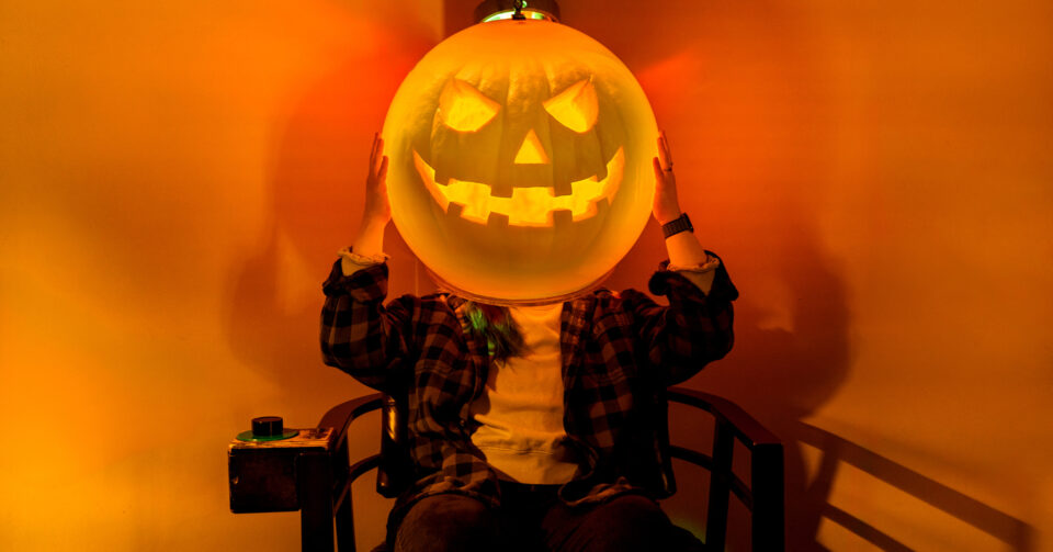 A jack-o-lantern face glows at the Exploratorium Creepatorium Halloween science party